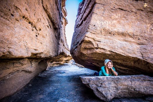 Woman enjoying a hike in a rocky canyon, showcasing stunning geological formations. Perfect for travel and exploration themes.